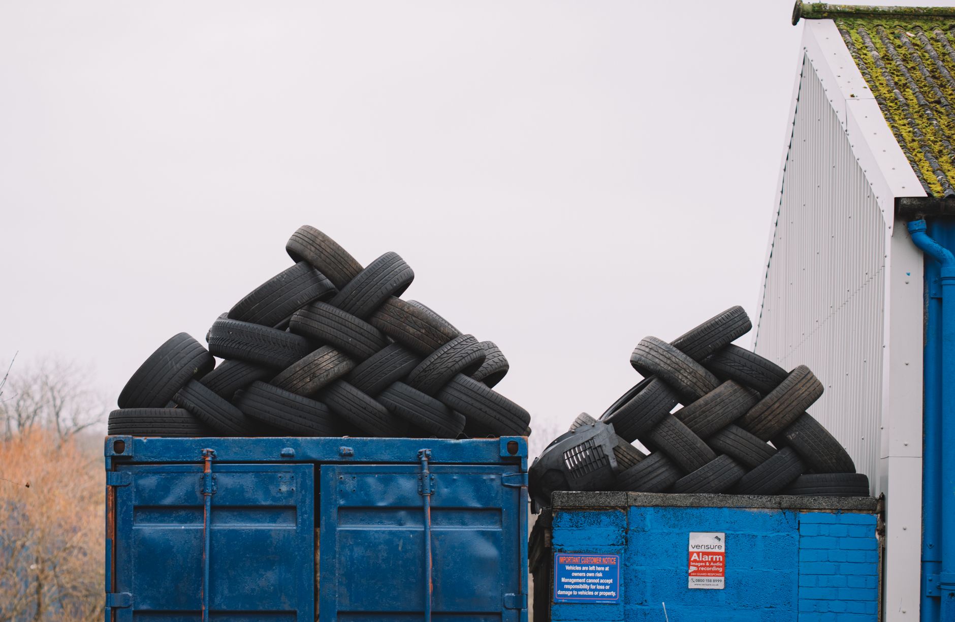 Discarded tires stacked in waste containers